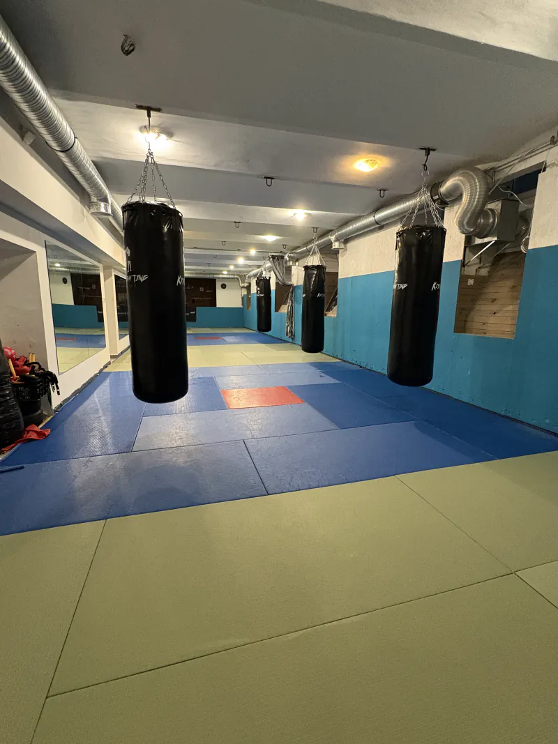 A tatamis edzőtér a függő boxzsákok felől